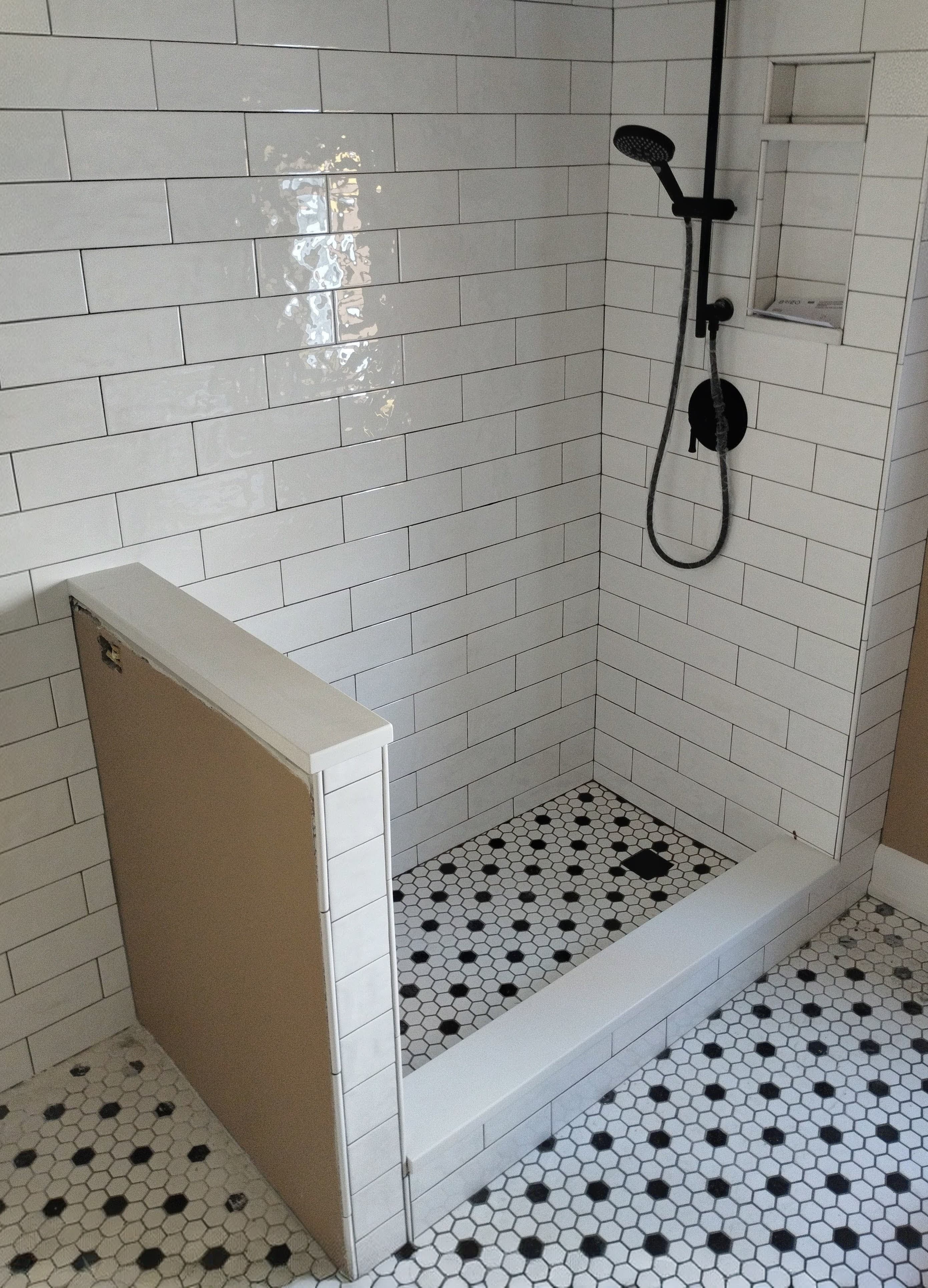 Modern white subway tile shower with matte black fixtures